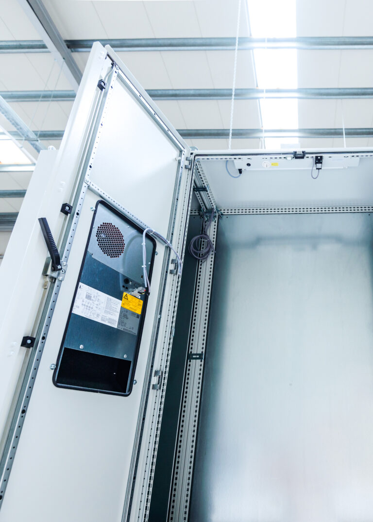 Industrial enclosure cabinet for electrical equipment with lamp and cooling unit.